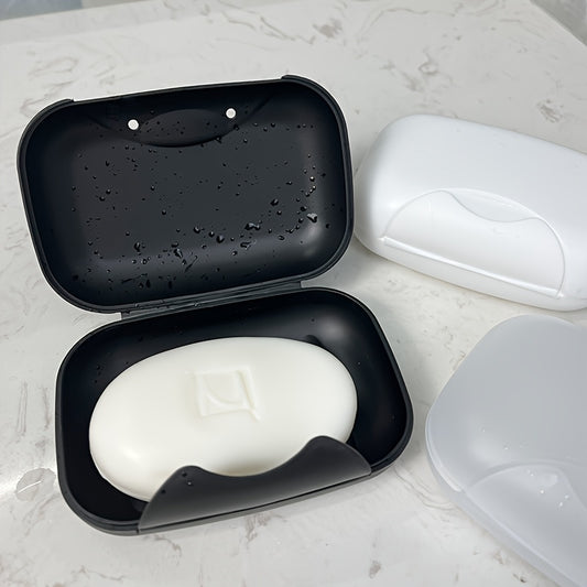 Travel-friendly plastic soap dish with lid, for convenient soap storage in the bathroom.