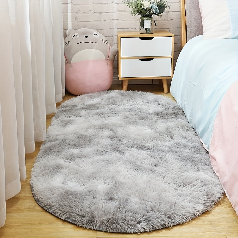 Soft and fluffy oval area rug, designed for use in living rooms, bedrooms, game rooms, and dormitories. Made of non-slip, washable polyester material. Machine-made shaggy rug perfect for adding a cozy touch to your space. Ideal for use as a bedside