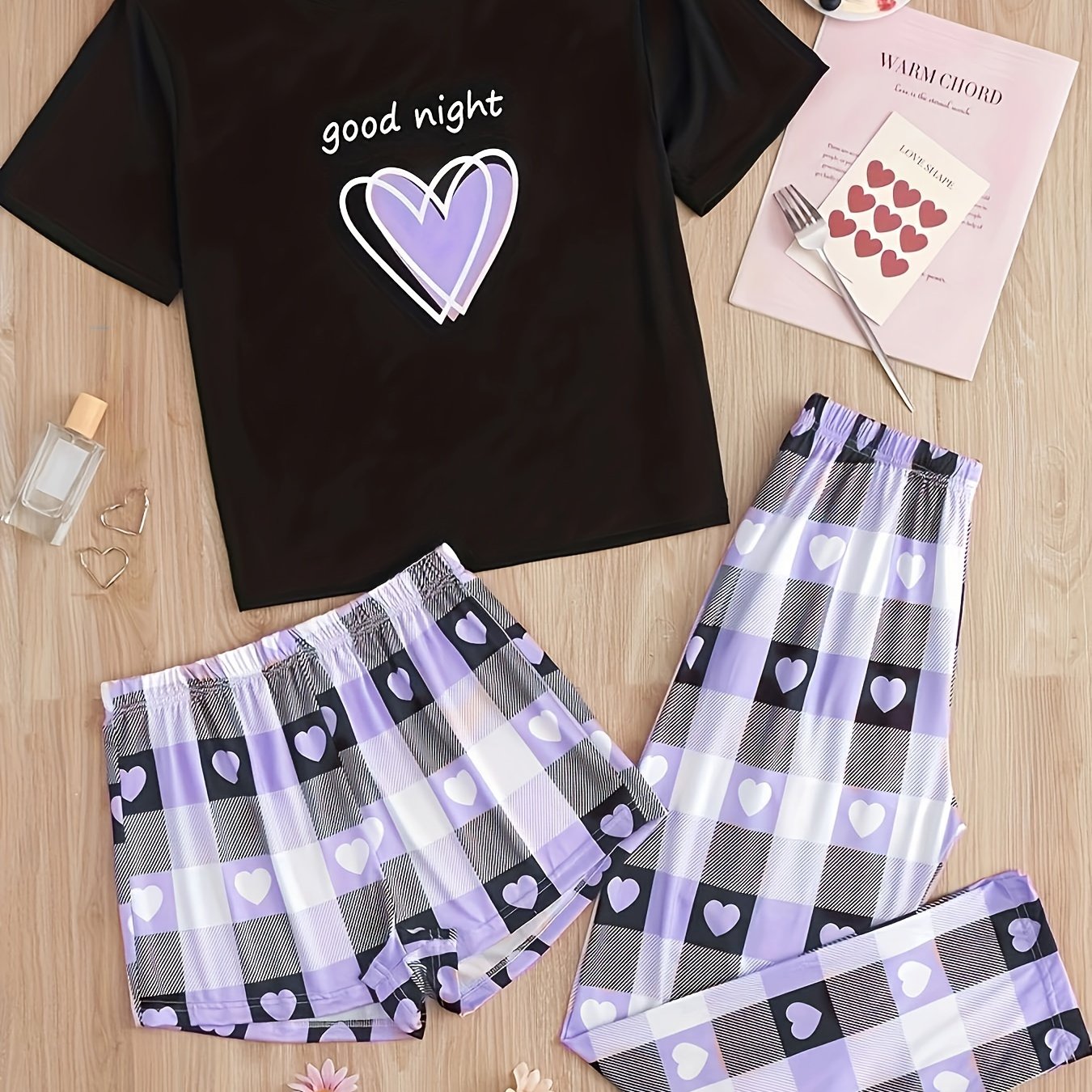 Women's casual pajama set with heart and plaid print, slogan, short sleeve top, and relaxed fit.