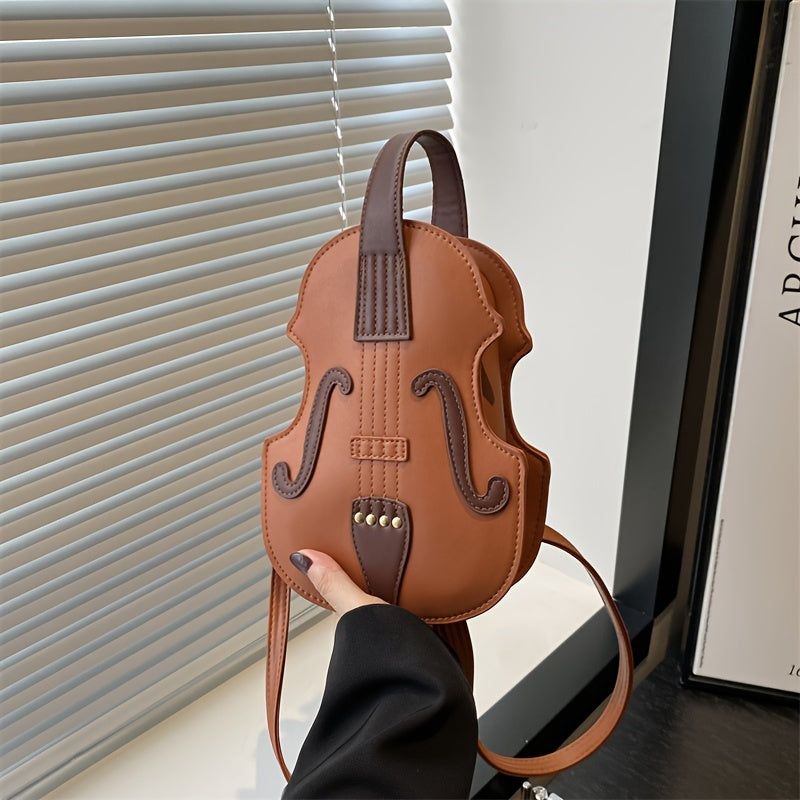 Stylish black/white violin-shaped crossbody bag with adjustable strap, perfect for casual use.