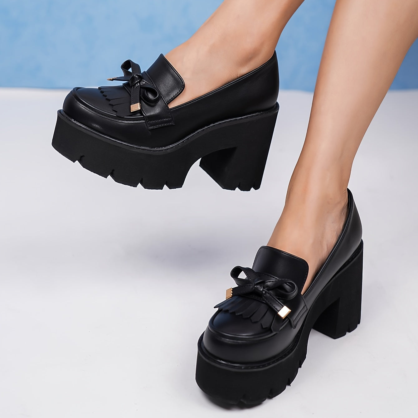 Black platform pumps for women with bow accent. Round toe, high heel shoes with lightweight rubber sole. All-season comfort with man-made materials.