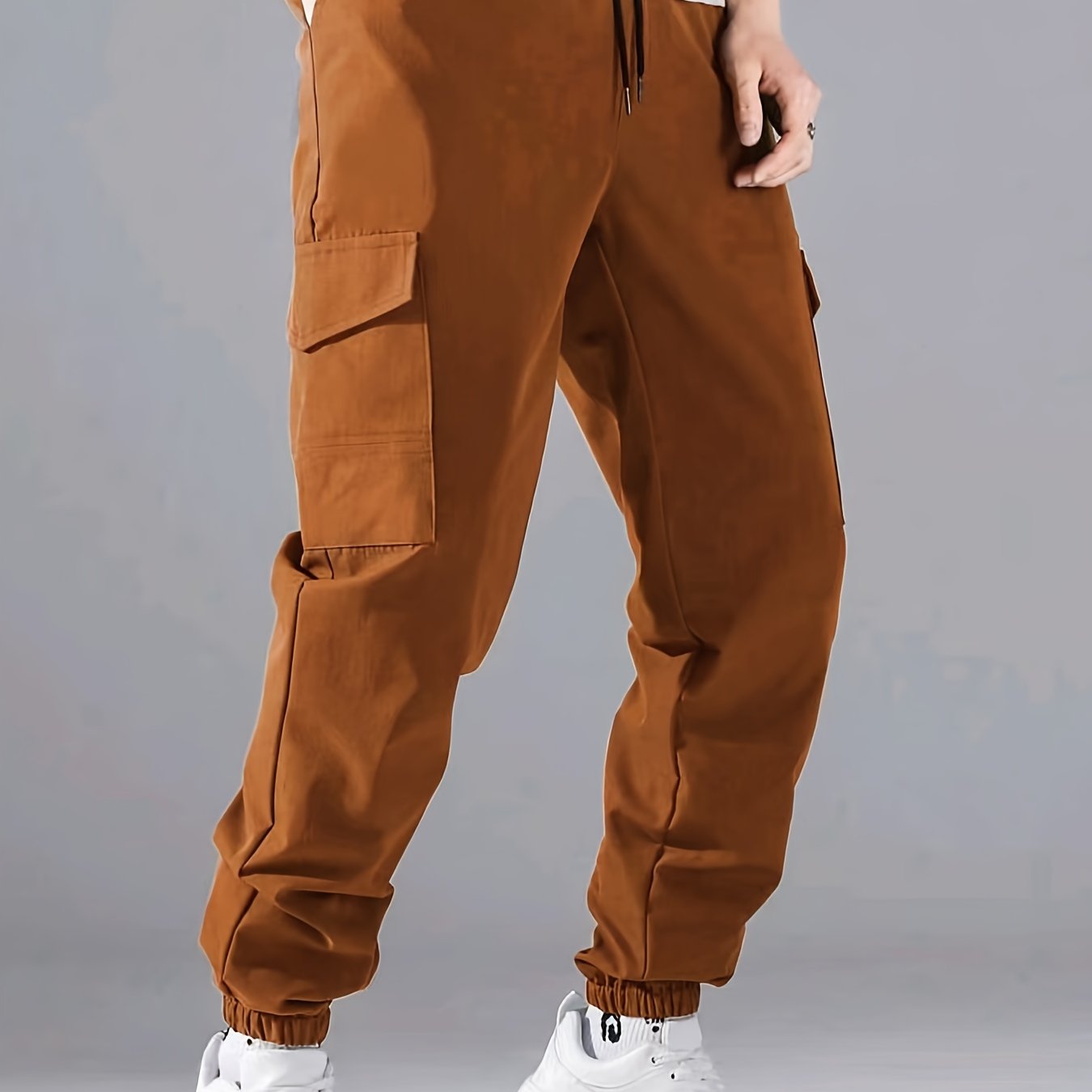 Men's casual joggers made of 100% polyester with a solid color, all-season, non-stretch fabric in a regular fit with pockets.