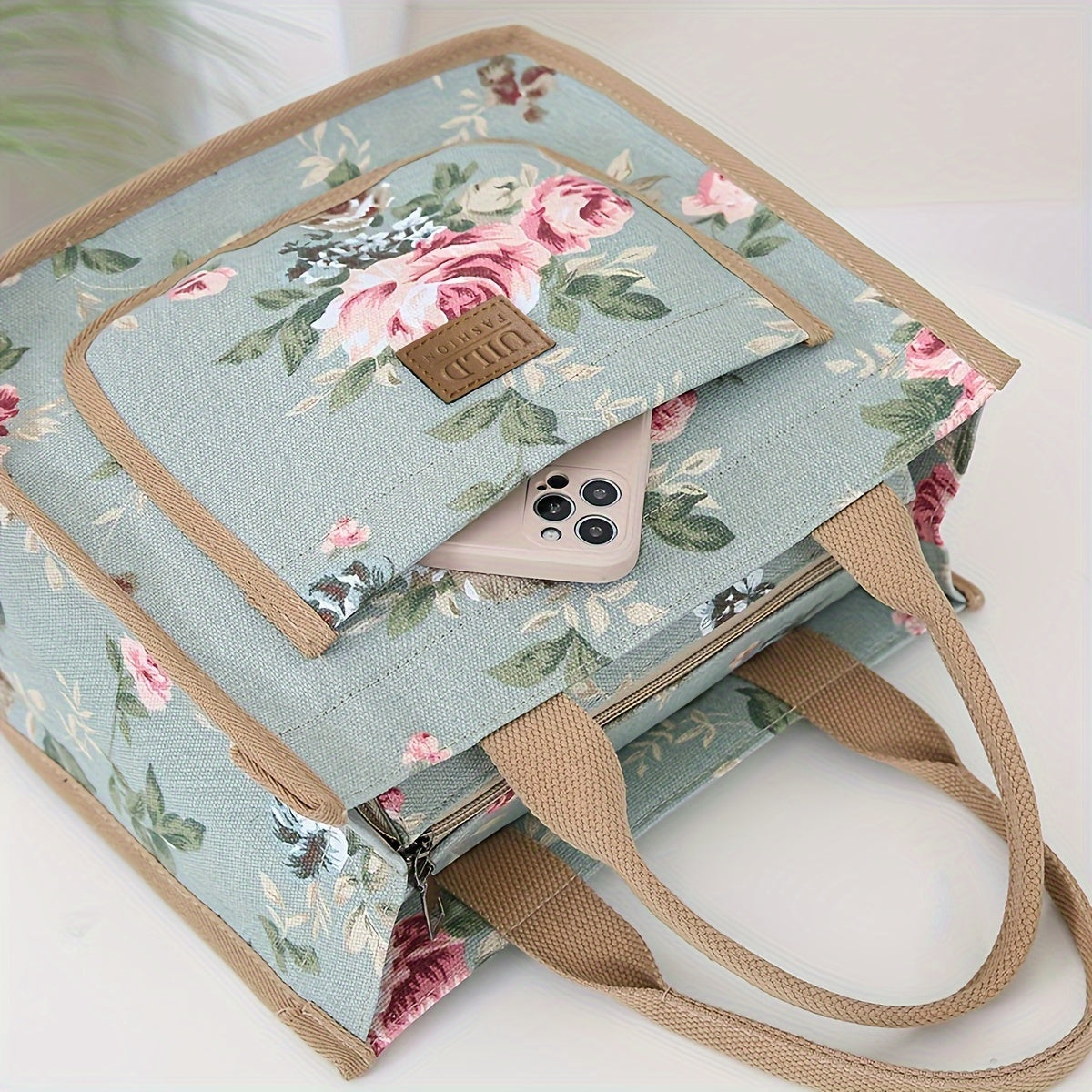 Large capacity portable tote for office and picnic featuring a floral print design on a canvas lunch bag. Hand washable and in a mixed color rectangle shape with a unique random print design. Includes 1 piece.