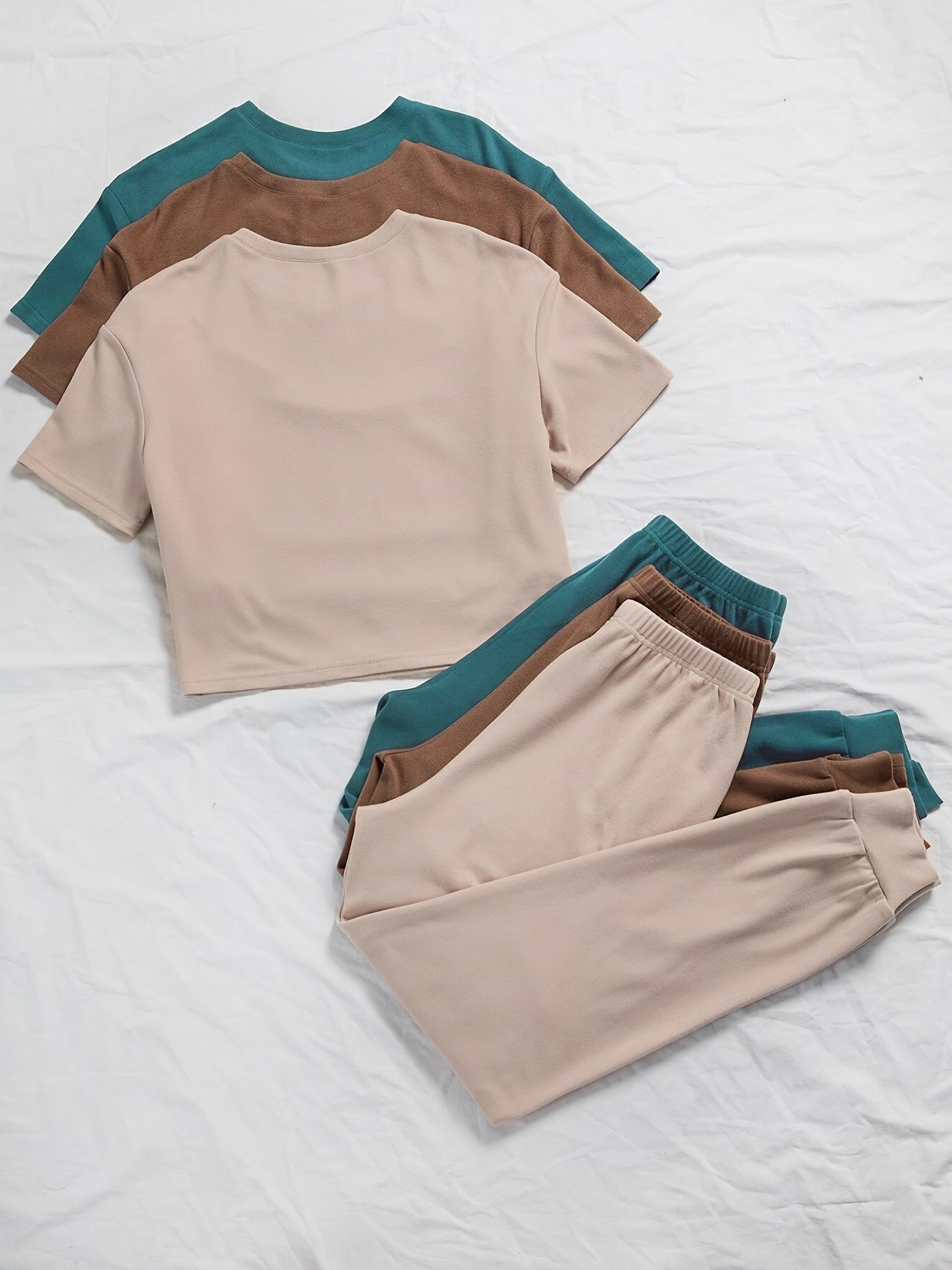 3 sets of women's solid color lounge sets with comfortable tee and tie front pants. Available in multiple colors for relaxed casual wear.