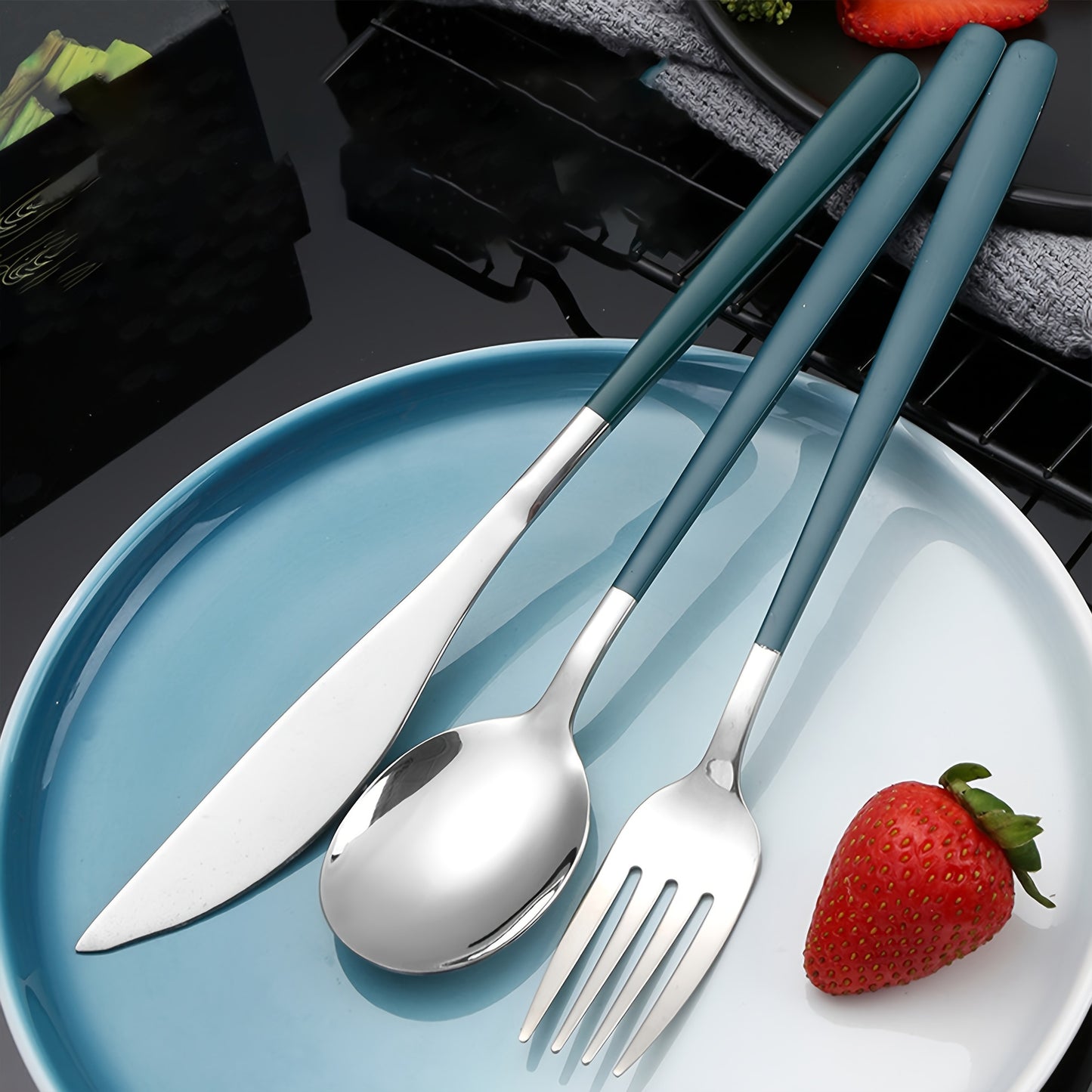 Stainless steel cutlery set includes knife, fork, spoon, and chopsticks in portable case for picnics, camping, lunches, and gatherings.