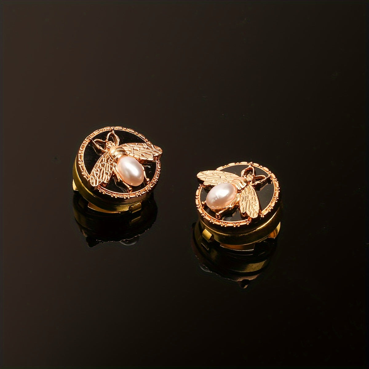 Get a pair of elegant Golden Bee cufflinks and shirt buttons set for a fashionable and seamless look. Made of shiny copper, these clip-on buttons are perfect for formal tailcoat attire and add a touch of luxurious decoration to your clothing. This fancy