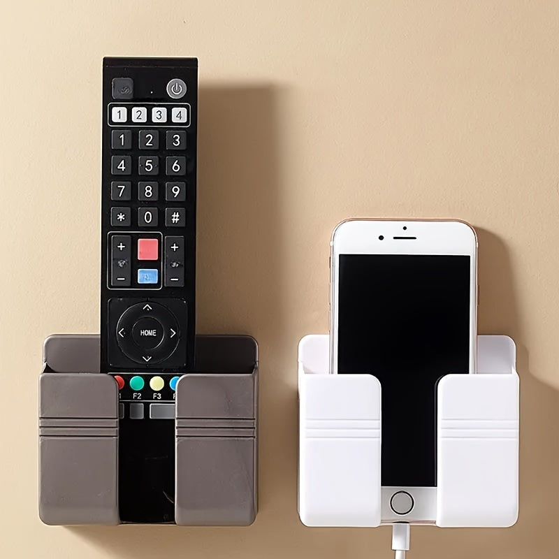 1pc Wall Mounted Phone Storage Rack for organizing remote controls and other items in various rooms.