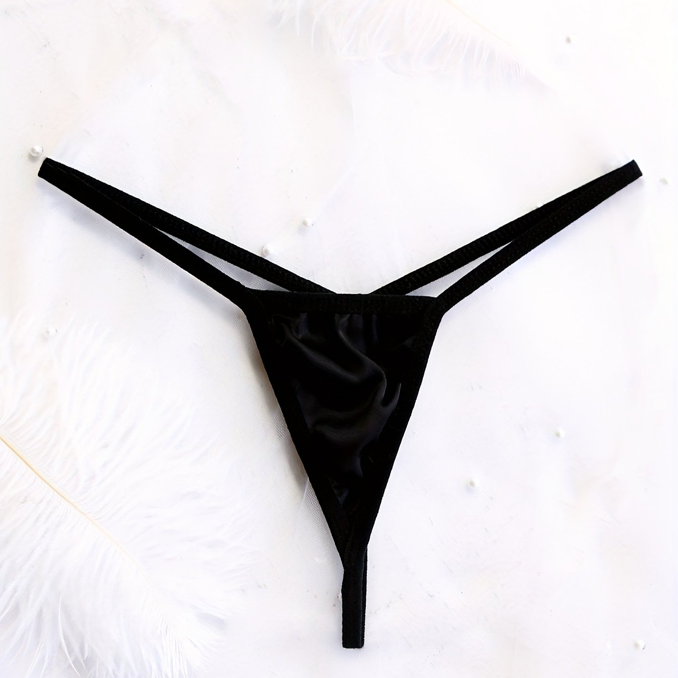 Seductive low-rise thong panties for women made with breathable nylon blend, featuring cross detail and semi-sheer sexy style.