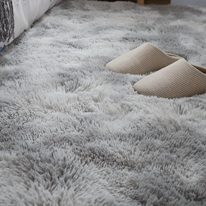 Soft fluffy area rug for bedroom, featuring a non-slip fuzzy shag plush design. This shaggy bedside rug is perfect for girls, kids, babies, teens, and dorm rooms. The tie-dyed pattern adds a fun touch to any living room or nursery. Measures 31.5*62.99