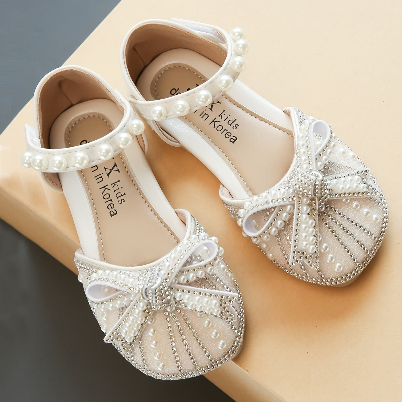 Sparkly bowknot flats with adjustable strap, durable TPR sole, comfortable for daily wear for girls aged 14 and under.