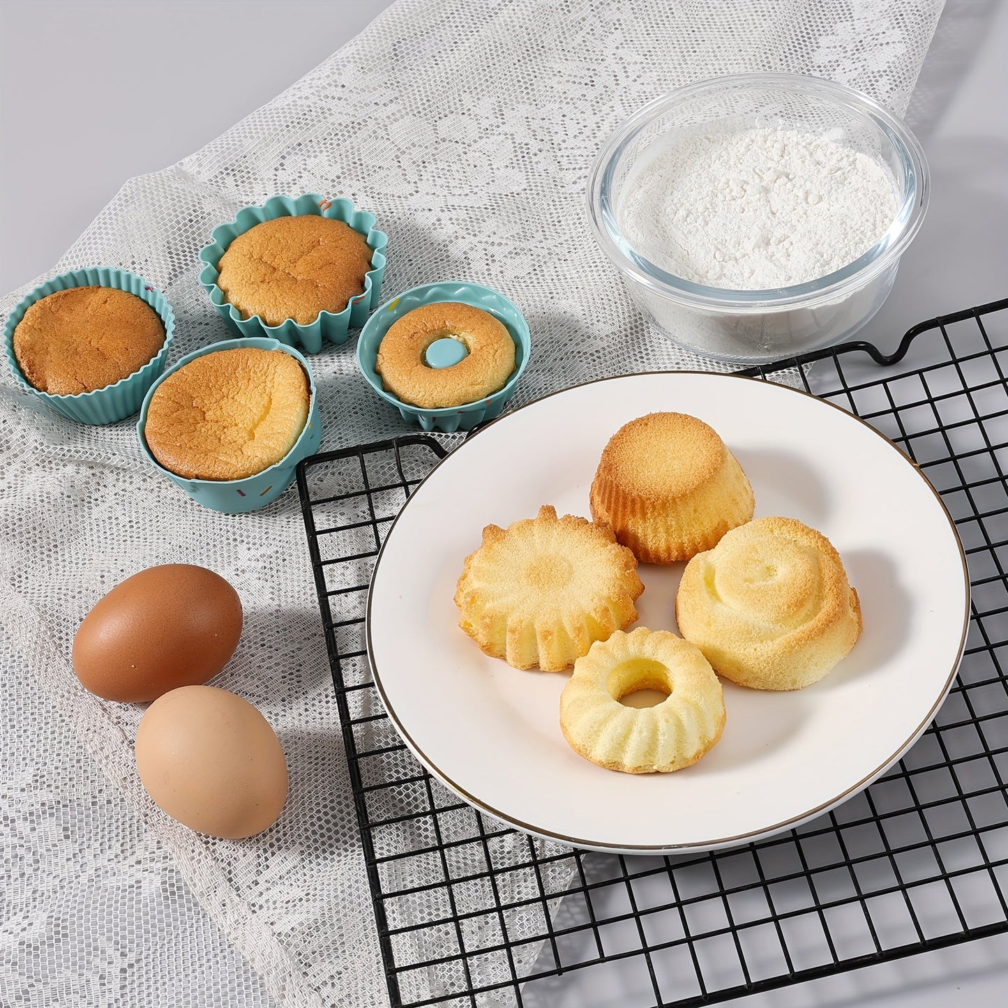 A 30-piece silicone kitchen baking supplies set includes nonstick silicone bakeware such as a baking pan, cake molds, baking sheet, donut pan, muffin pan, and cake pan, as well as a 24-pack of silicone cupcake mold baking cups.