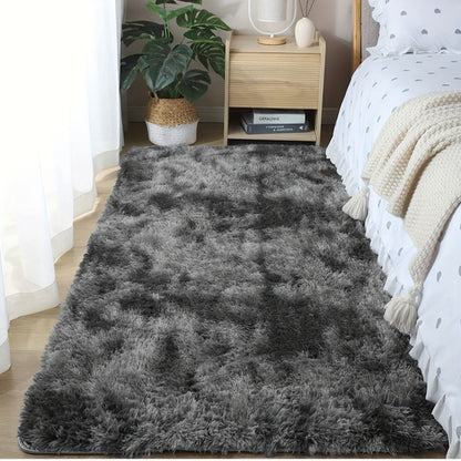 Soft fluffy area rug for bedroom, featuring a non-slip fuzzy shag plush design. This shaggy bedside rug is perfect for girls, kids, babies, teens, and dorm rooms. The tie-dyed pattern adds a fun touch to any living room or nursery. Measures 31.5*62.99