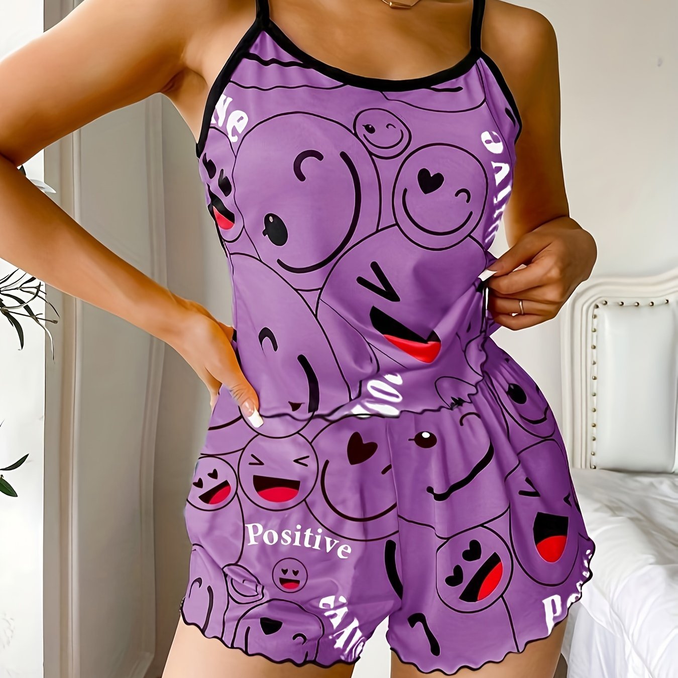 Women's sleepwear set with smiling face print cami top and elastic shorts.