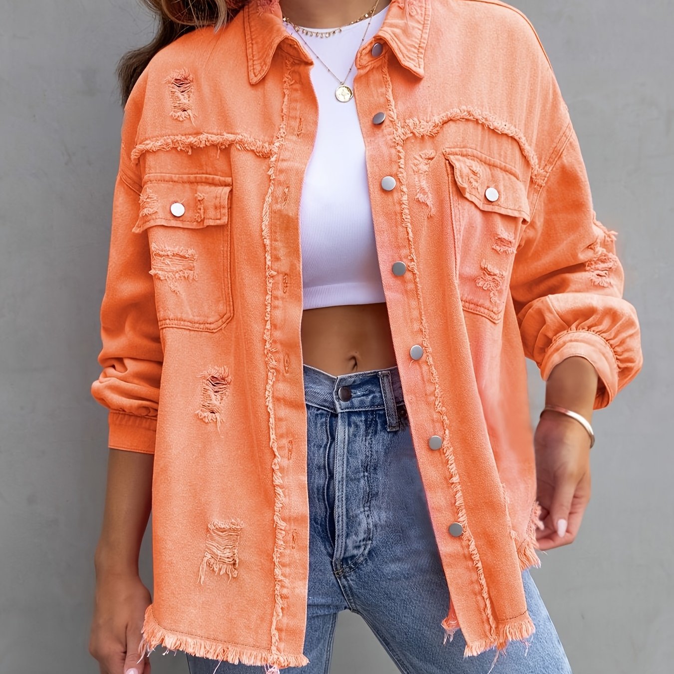 Women's plus size distressed denim jacket with boho style, button detail, and lapel collar made of rayon/viscose blend fabric. Suitable for spring/fall fashion.