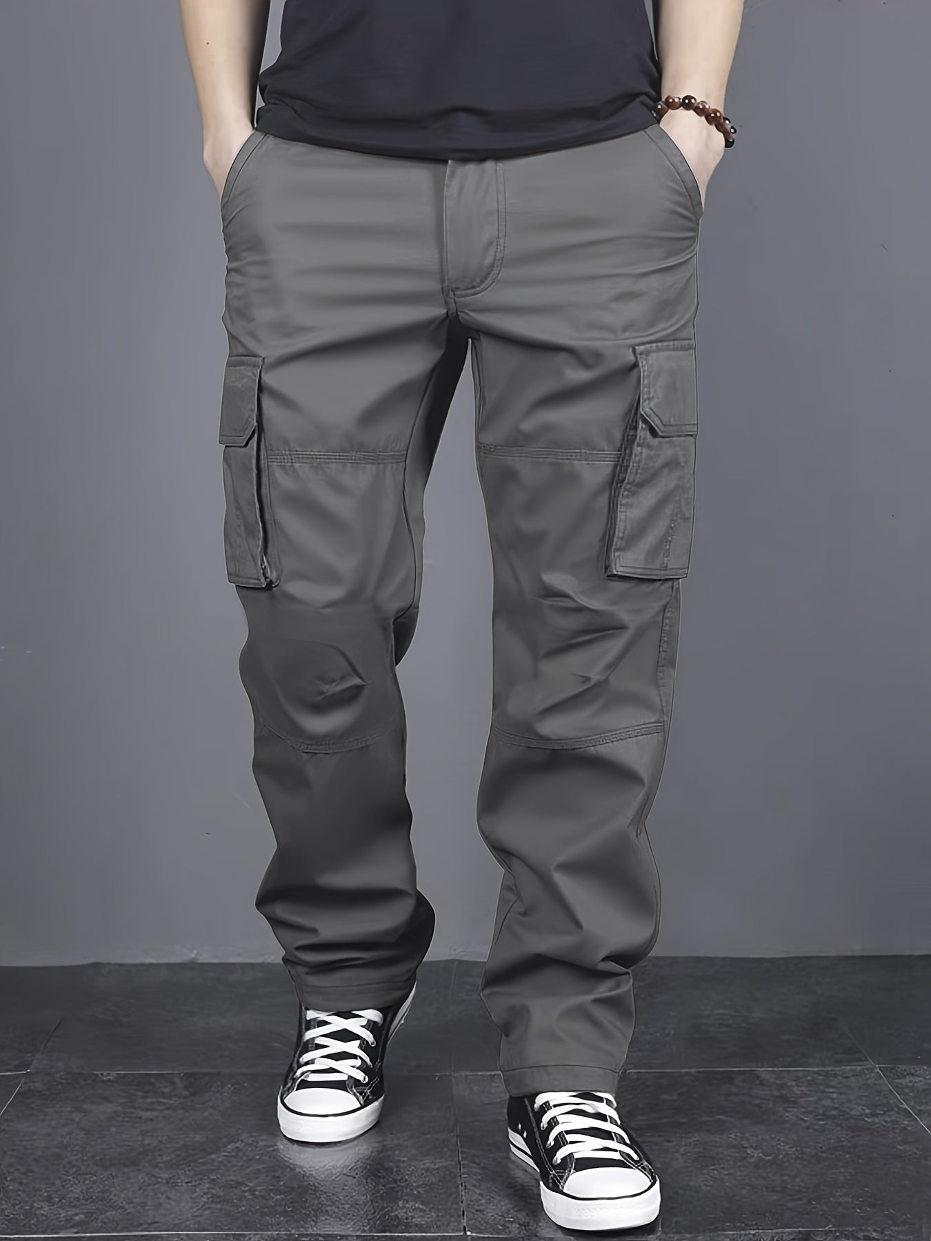 Solid color cargo pants with multiple flap pockets and a drawstring waistband, perfect for outdoor activities like hiking, fishing, and camping.