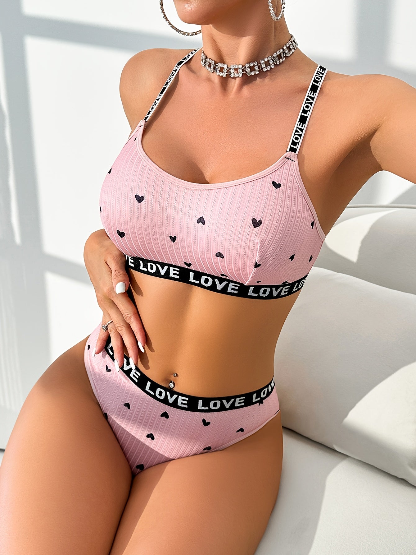 Women's sexy heart print lingerie set made from polyester knit fabric with LOVE strap detail, braid accent. Adult intimate apparel.