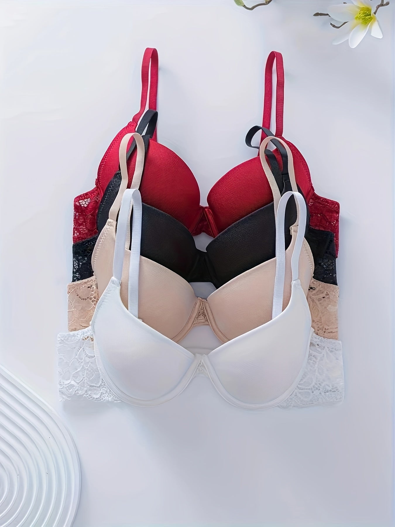 4-pack of women's push-up bras with removable pads and shoulder detail, made of high support nylon knit material.