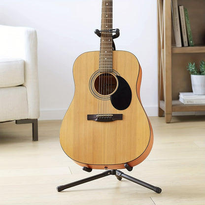 Vertical guitar stand with X-shaped base for stability, ideal for displaying acoustic and electric guitars in bedroom.