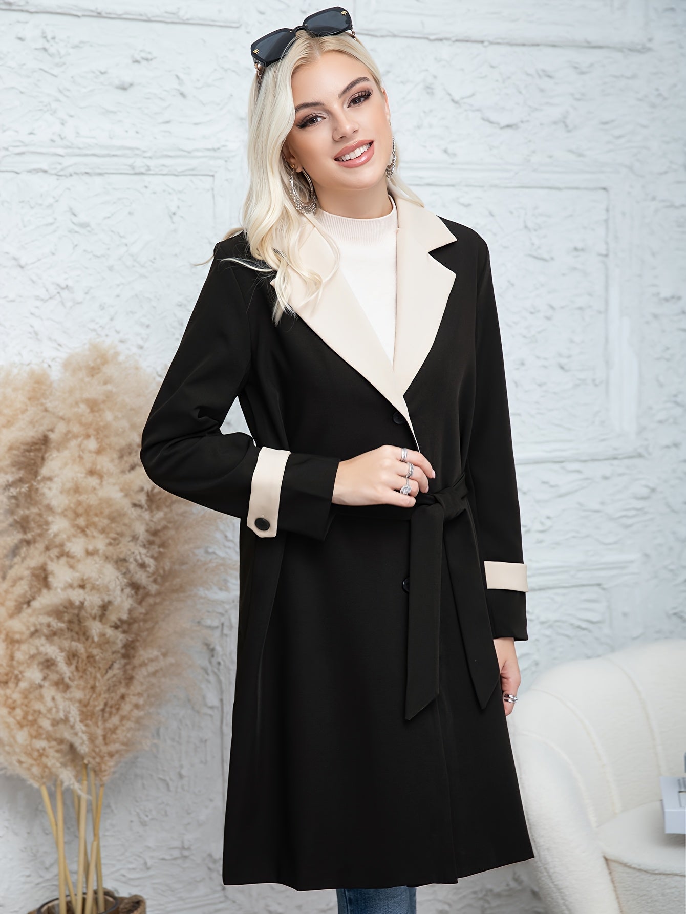 Women's long coat for autumn/winter fashion with contrast color, solid pattern, button detail, woven polyester fabric, and thick outerwear suitable for both trench coat and raincoat.