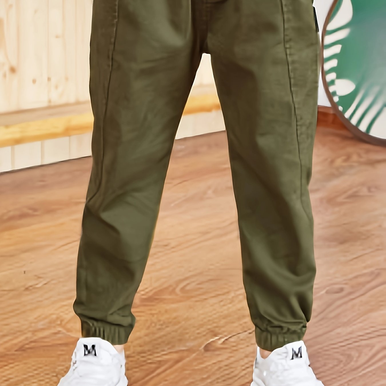 Boys' slim fit khaki cargo pants made with a durable cotton blend, featuring an elastic waist and pockets. Ideal for hiking, sports, and everyday wear.