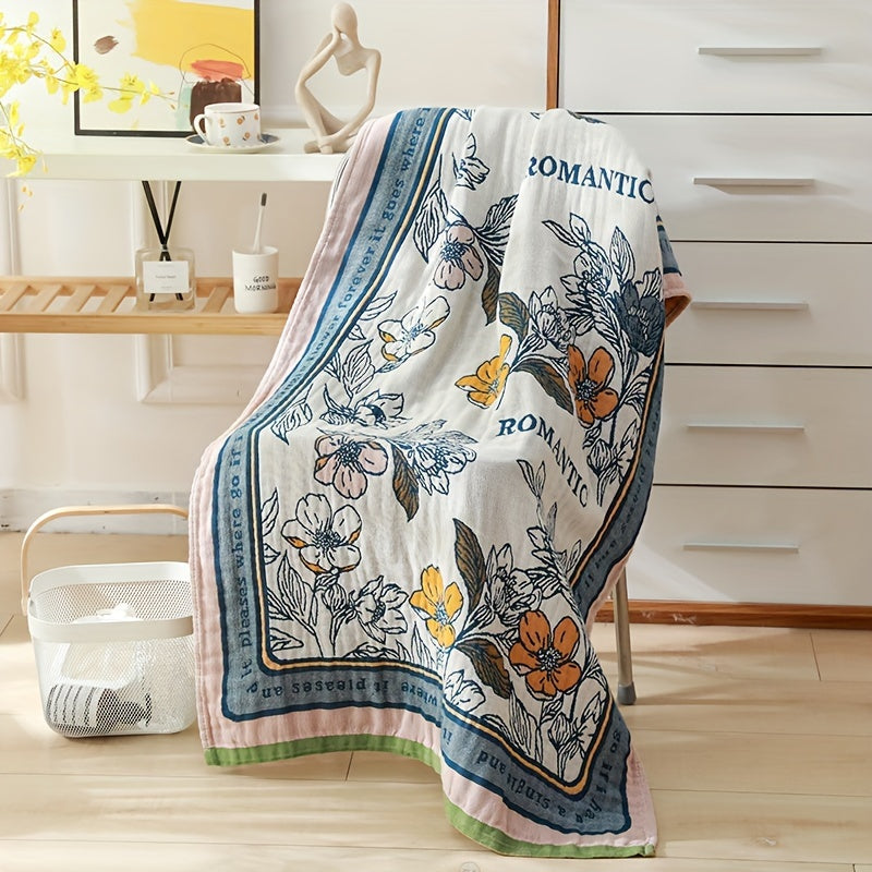 Large floral beach wrap towel made of super absorbent cotton with a four-layer design. Features a vibrant orange, blue, and green floral pattern. Soft, quick-drying, and perfect for home or travel.