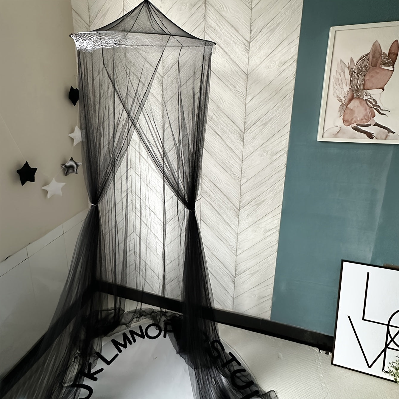 This black dome mosquito net features lace trim, a top and door ribbon, and ruffles. It is suitable for single, double, and queen beds, and makes a stylish addition to any bedroom decor. Made from polyester fabric weighing 200-250g, this net does not