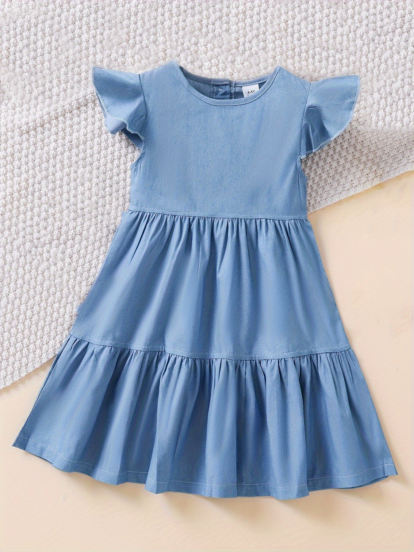 Stylish denim dress for girls with ruffle trim, made of cotton blend and machine washable, ideal for summer