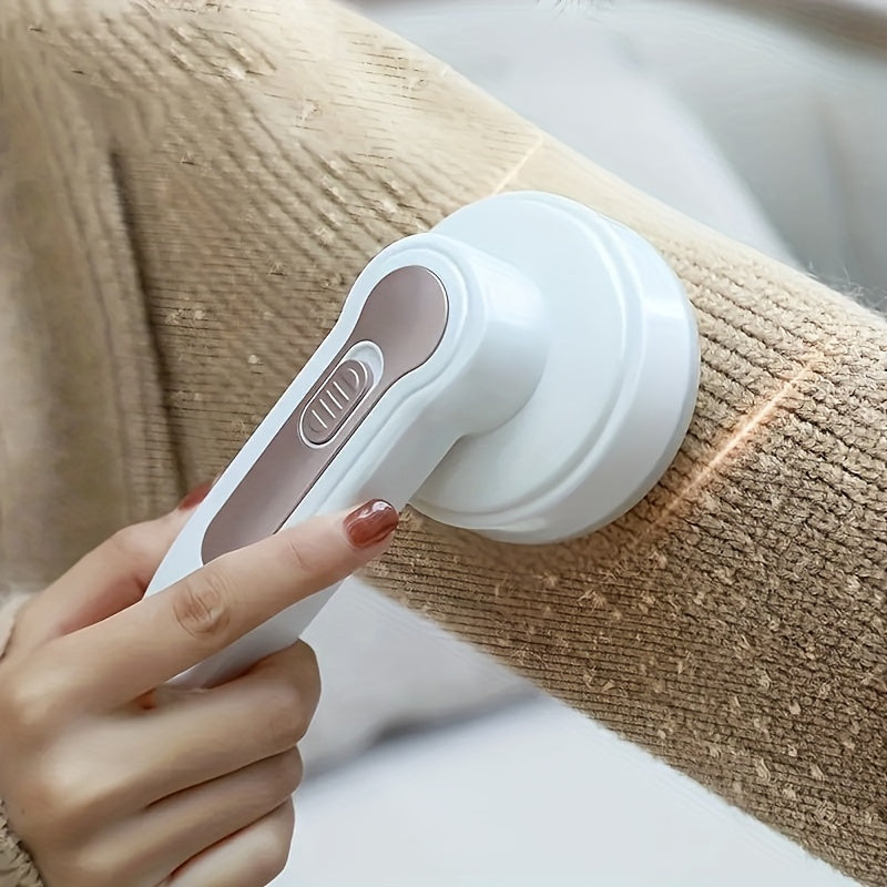 Portable rechargeable electric lint remover effectively removes pill fuzz from clothing, furniture, and carpet with USB cable and cleaning brush.