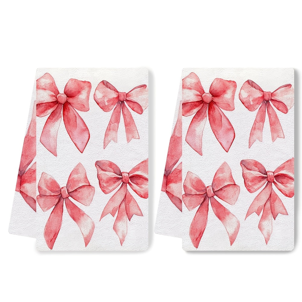 Two ultra soft kitchen towels featuring a Valentine's Day bows design. These towels are highly absorbent, machine washable, and measure 40.64x60.96 cm. The contemporary red bow pattern is perfect for holiday decor.