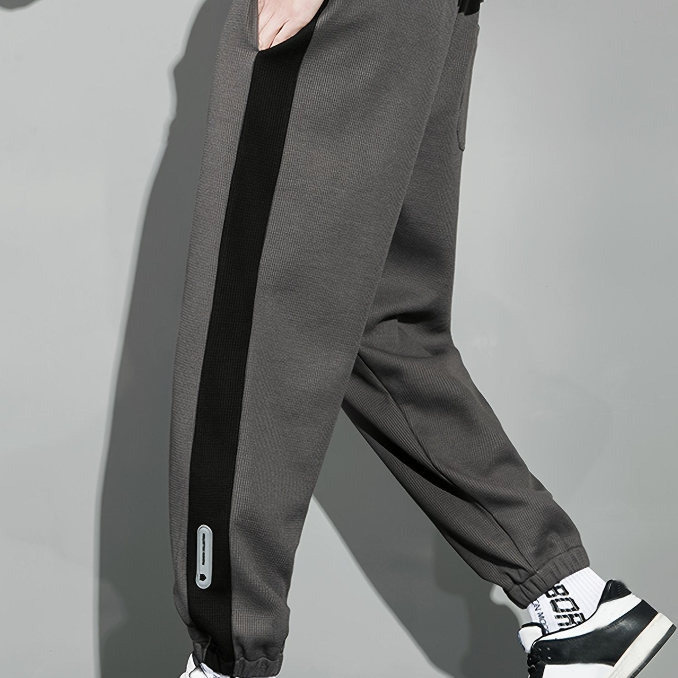 Men's casual joggers with contrast side stripe, elastic waist drawstring, regular fit tapered leg for leisure.