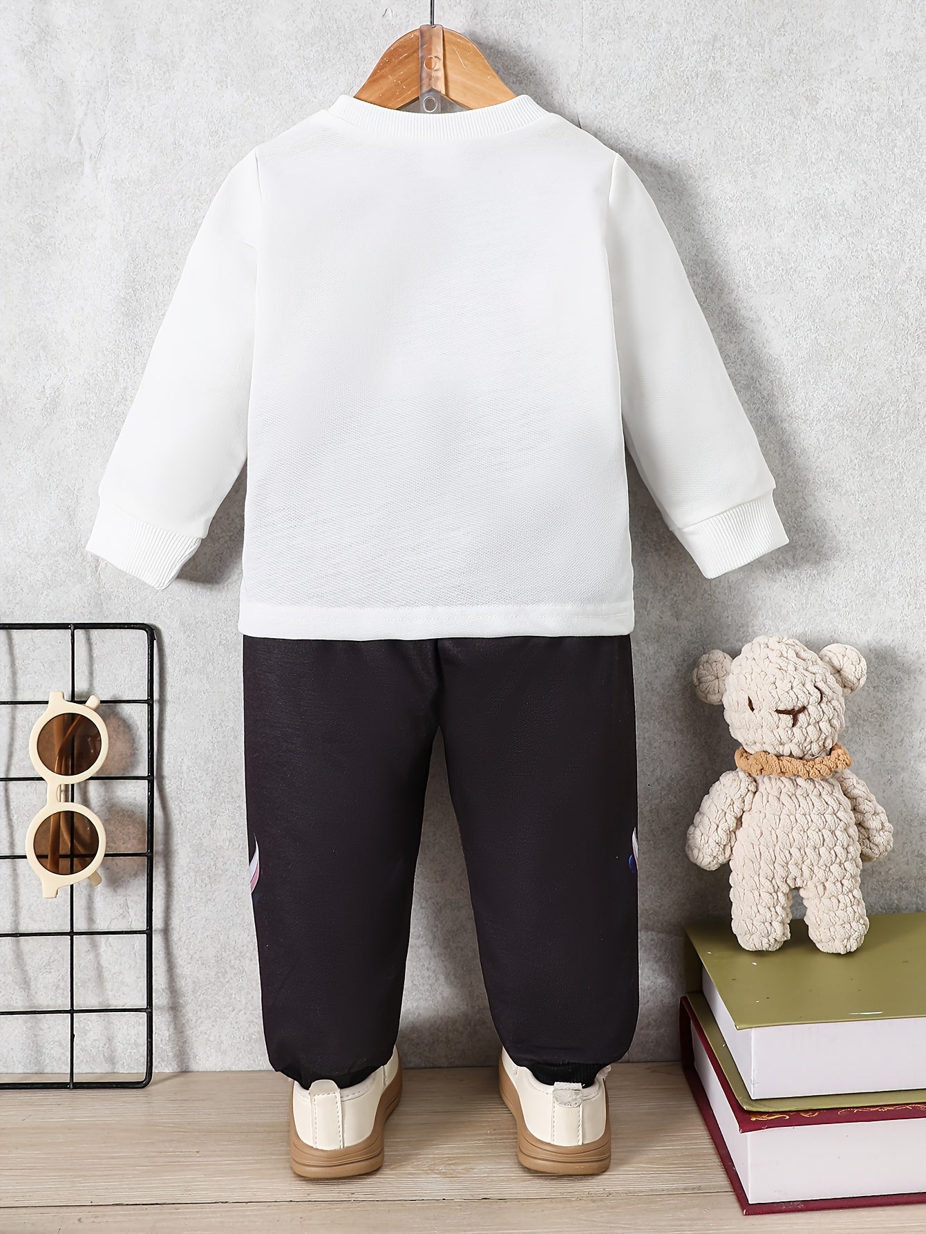 Newborn boy's trendy sweatshirt and pants set with hooded bear print, ideal for fall and winter.