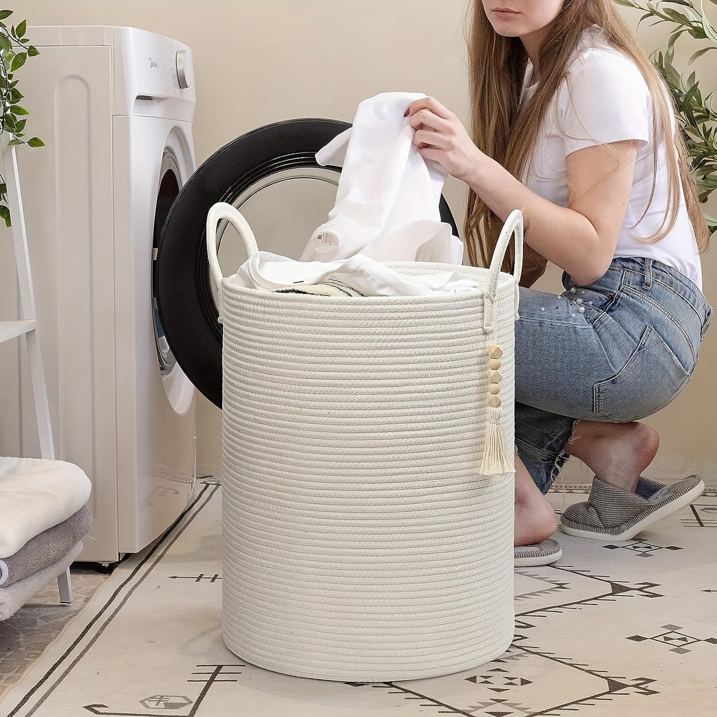 This tall laundry basket measures 40.64cm X 50.8cm and features a woven design with a convenient handle. It can be used as a blanket organizer in the living room, a storage basket for dog toys, or a decorative jute laundry hamper for clothes, pillows