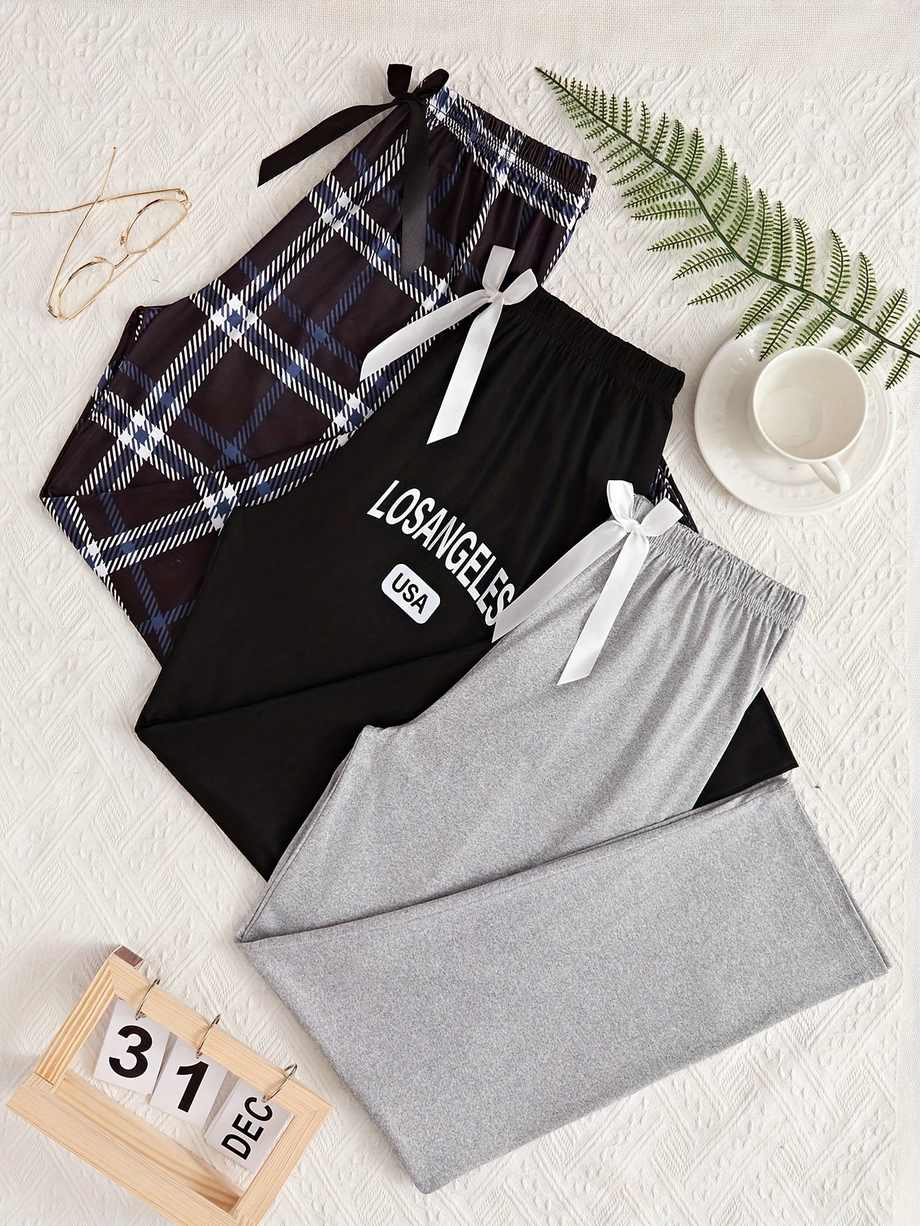 3 Casual lounge bottoms with solid, letter, or plaid print, high waist and loose fit for women's sleepwear.