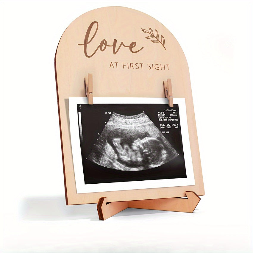 Wooden ultrasound photo frame with sign, ink pad. Perfect gift for new parents. Decorative room accessory and cherished memories display. Ideal shower keepsake.