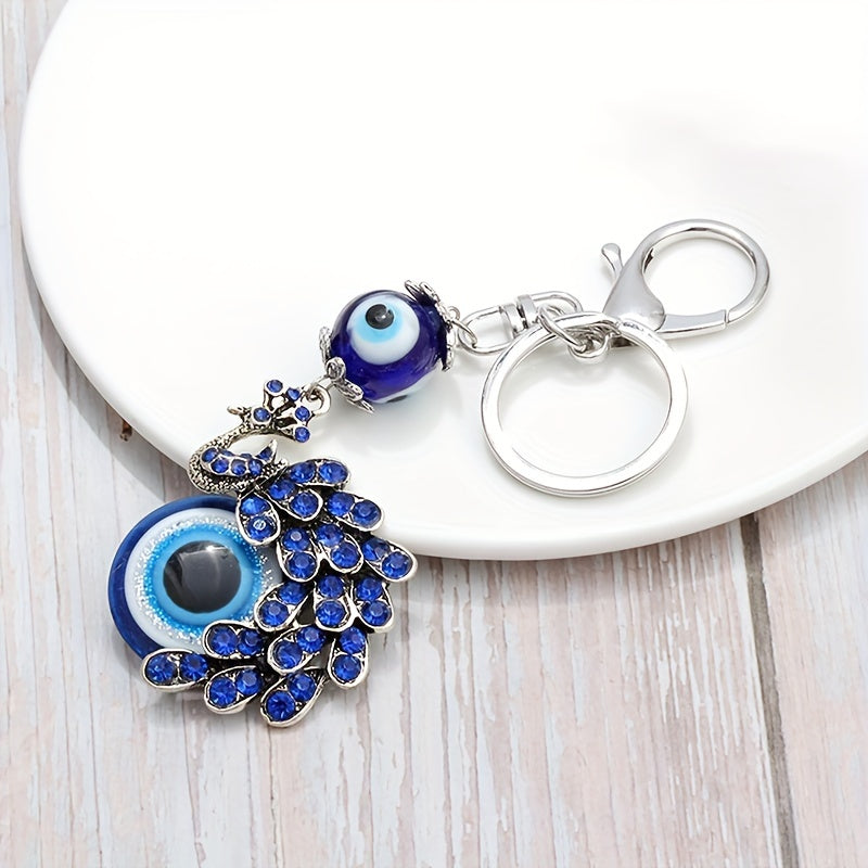 Blue Evil Eye Keychain with Rhinestone Inlaid Peacock Design, made from Alloy, Perfect for Women's Daily Use as a Trendy Hanging Pendant or Bag Charm.