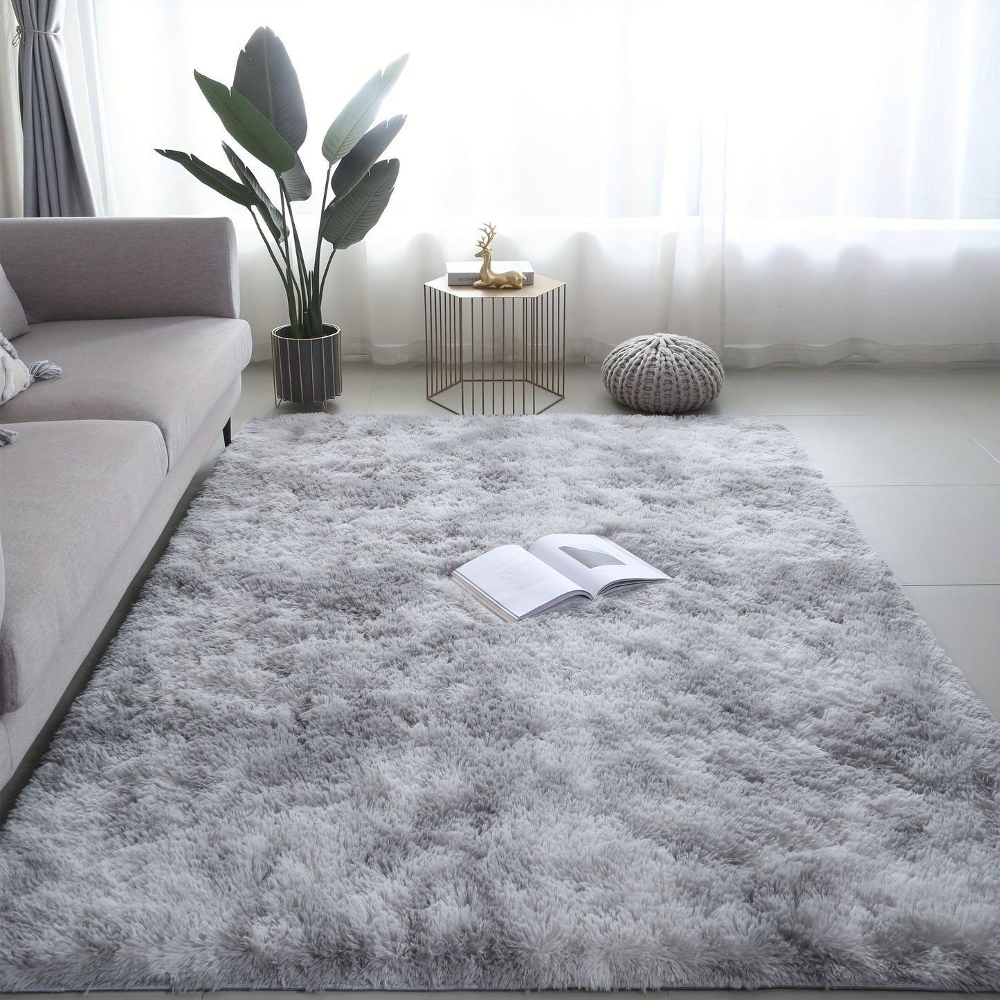 A stylish light grey tie-dye gradient plush carpet perfect for your living room, coffee table, or bedside. This long-haired washable mat is ideal for adding a touch of Nordic style to your bedroom.