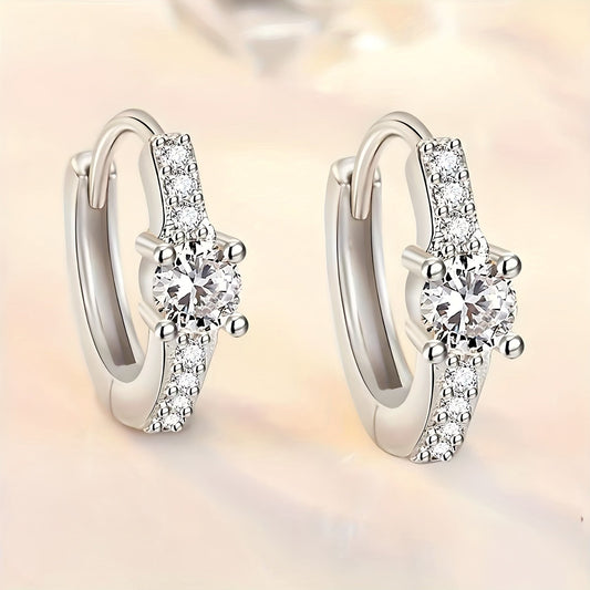 A chic and stylish pair of S925 Silvery earrings, featuring a retro, exquisite design with trendy and luxurious appeal. These earrings exude elegance and sweetness, adorned with shiny rhinestones in a round hollow shape. The high-end design showcases a