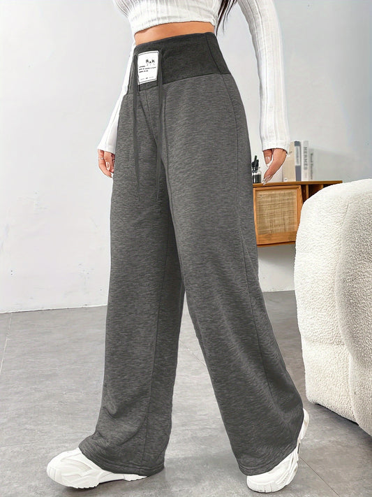 Women's plus size wide leg pants made of solid color polyester knit fabric with medium stretch, high waist and drawstring closure for all-season comfort.