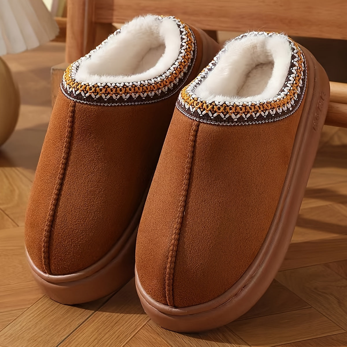 Winter slip-on slippers with cozy fabric, EVA sole, and machine washable design for both men and women.