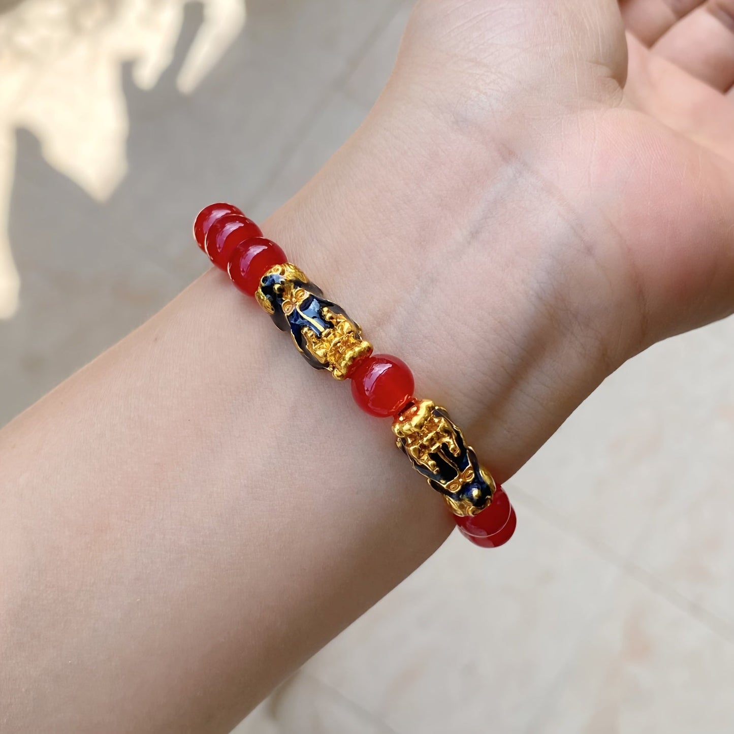 Two Pixiu bracelets, one in red antique style, offering a safe and lucky accessory. This classic, luxurious piece symbolizes prosperity and is beautifully crafted with shiny, artificial jewels. Perfect for gifting to girlfriends, sisters, or mothers to