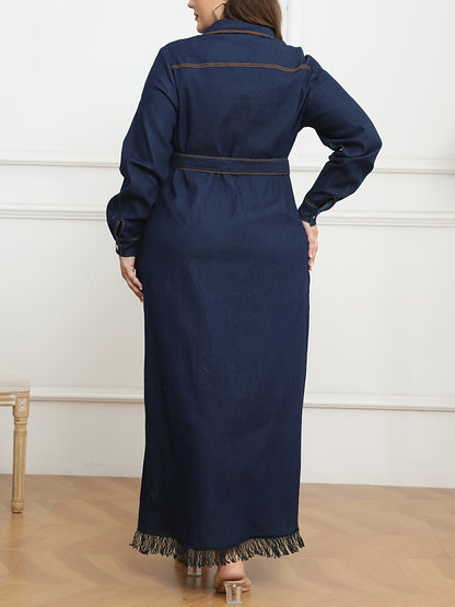 Women's plus size navy blue denim dress with long sleeves, button-up shirt collar, fringe hem, belt detail, and cotton/polyester blend. Machine washable.