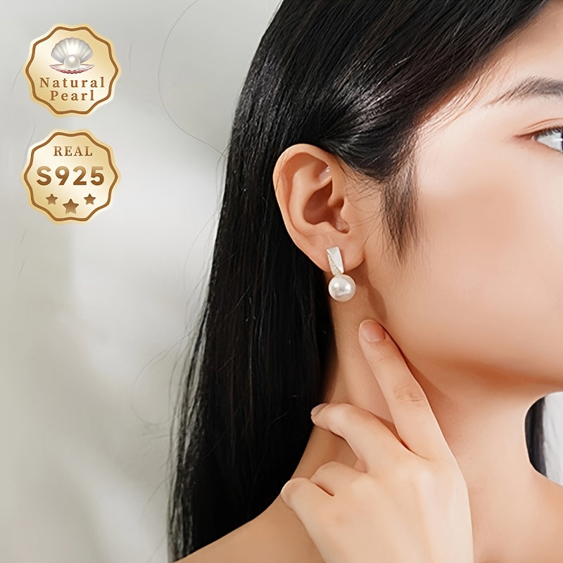 Surprise someone special with this must-have gift box containing a pair of fashionable dangling earrings for women. Made with S925 silver and featuring lustrous 11-12mm round natural freshwater pearls, each pair is unique as the natural pearls come in