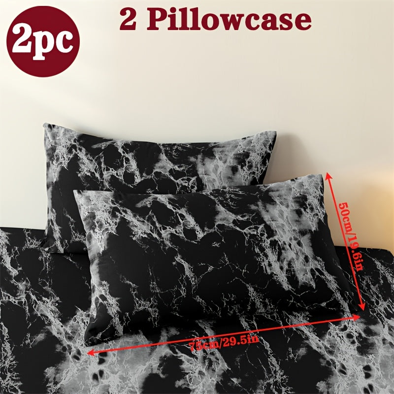 Two geometric print pillowcases made from soft and breathable polyester microfiber. These pillowcases are machine washable and feature an envelope closure for easy use. Perfect for adding a stylish touch to your home bedding, these pillowcases do not