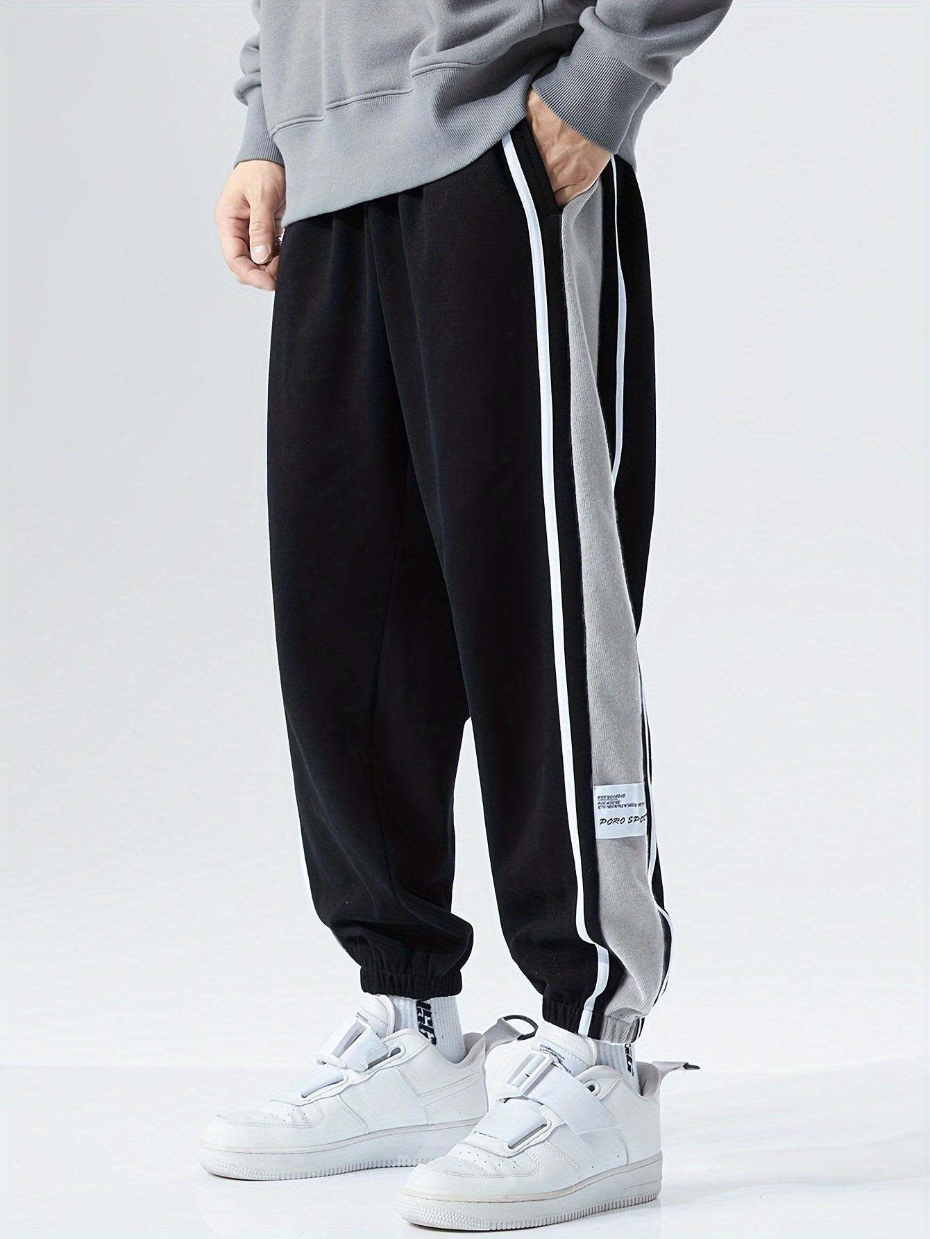 Men's loose sports pants for summer and fall, trendy style, available in large sizes, suitable for casual wear.