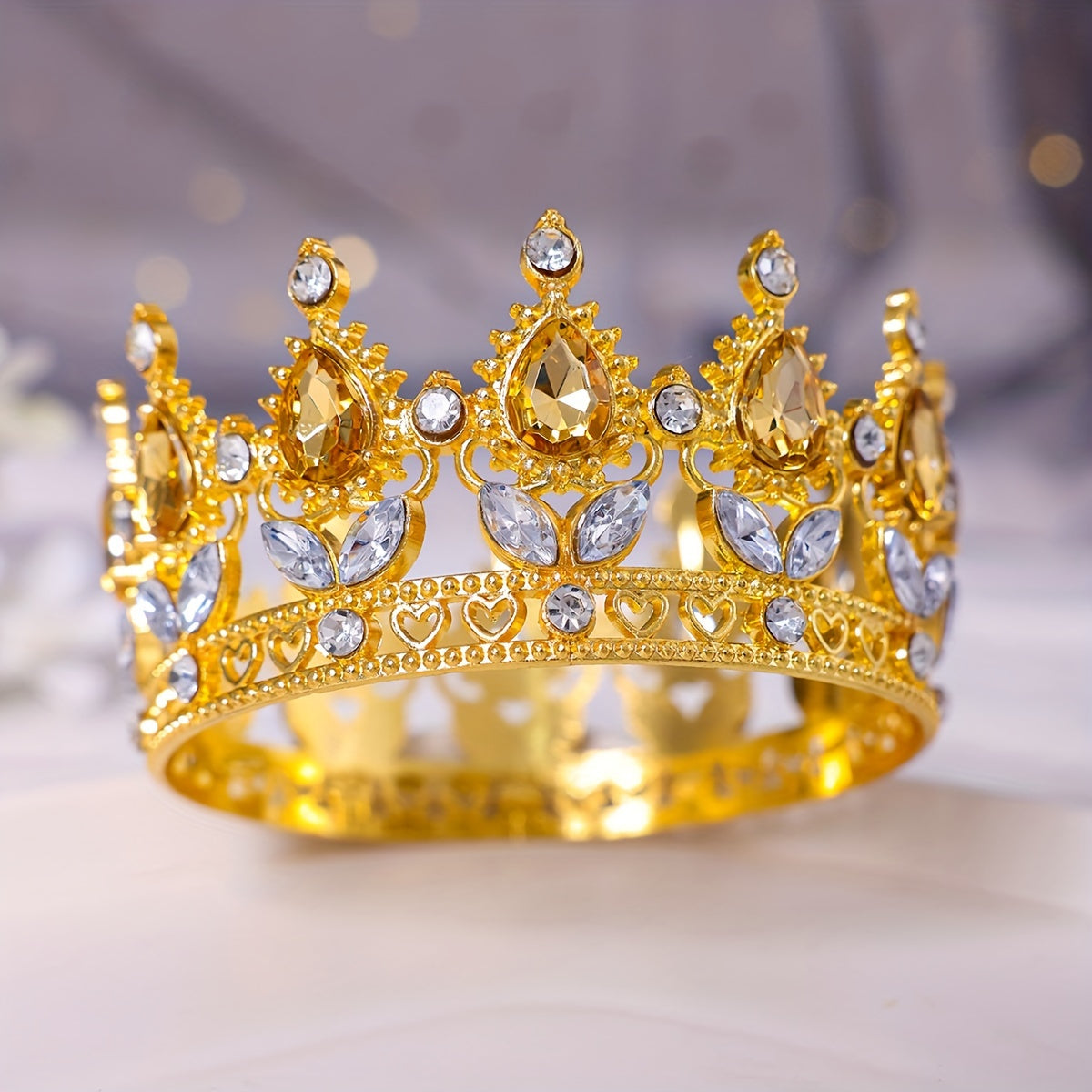 This stunning Baroque style bridal tiara features intricate golden water diamond embellishments, making it ideal for beauty pageants, proms, and formal events. Adorned with delicate flowers in a beautiful full circle design, this tiara is perfect for