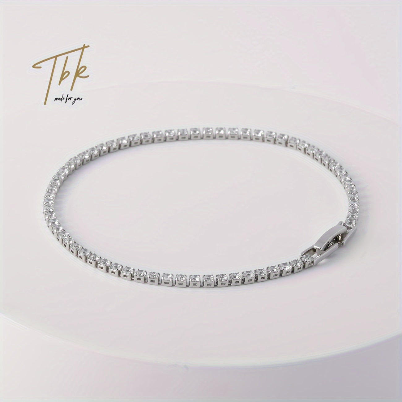 Ice up with this dazzling zirconium-studded tennis bracelet made of shiny titanium steel, presented in a gift box for an extra touch of luxury.