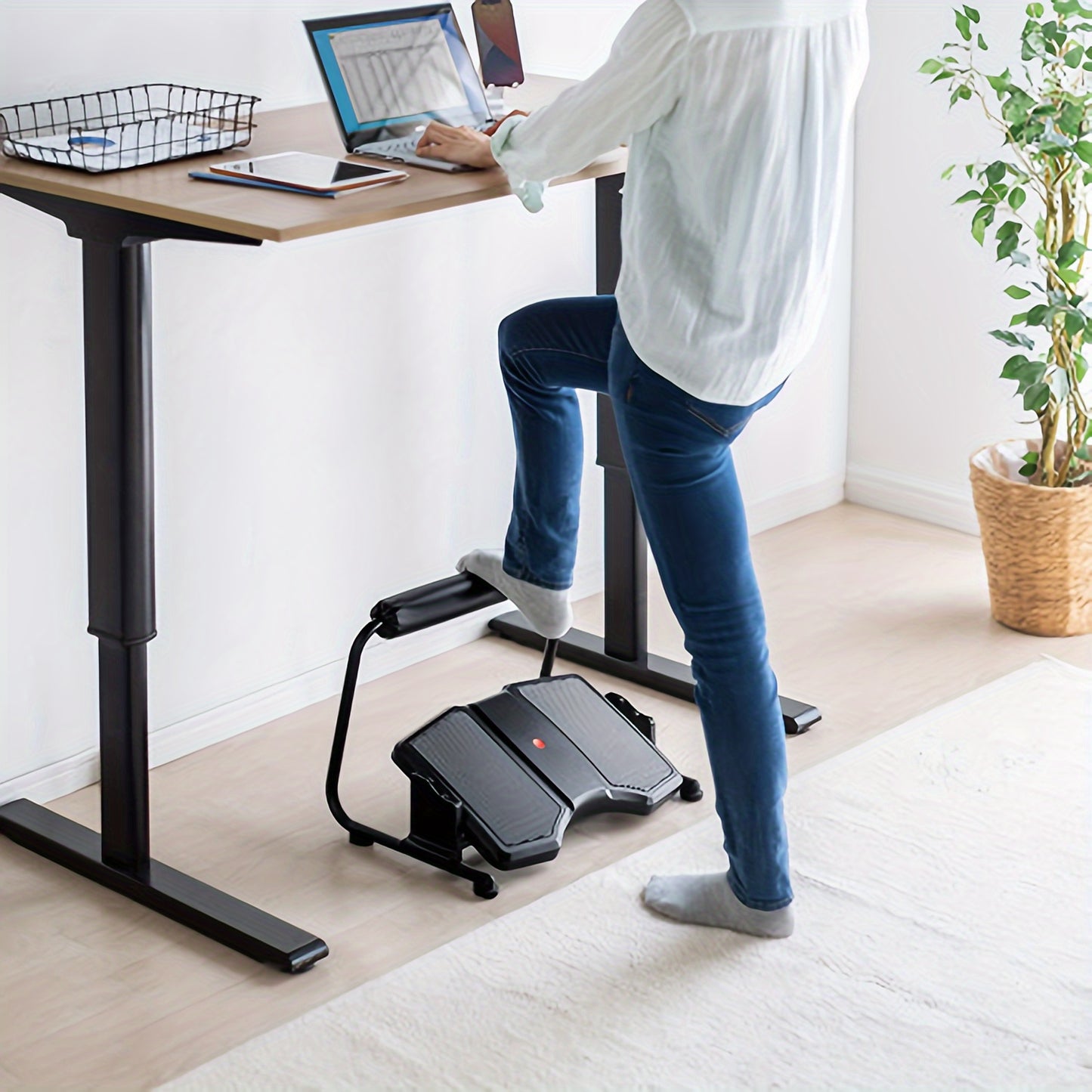 Adjustable ergonomic footrest stool for office use, non-electric, black plastic material.