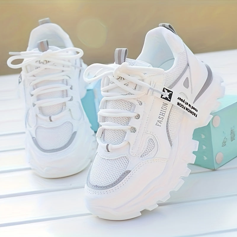 Women's white sneakers with low top lace-up, mesh upper, breathable fabric insole, and durable PVC sole for casual and sporty wear. Casual and trendy footwear.