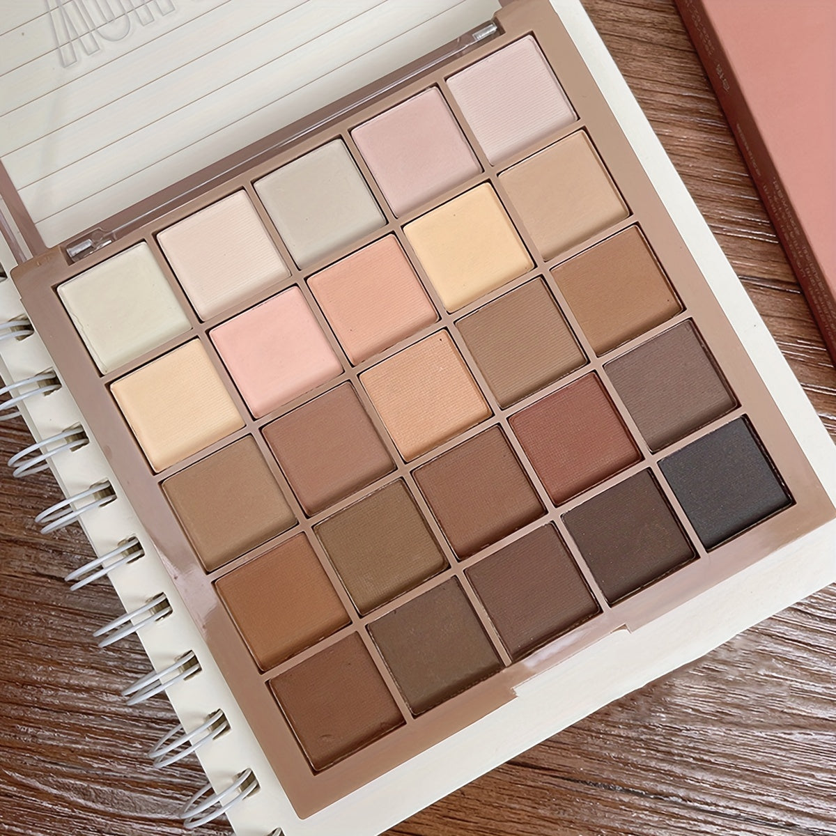 Eyeshadow Palette with 25 matte shades in neutral grey and brown earth tones for versatile makeup looks inspired by coffee and chocolate.