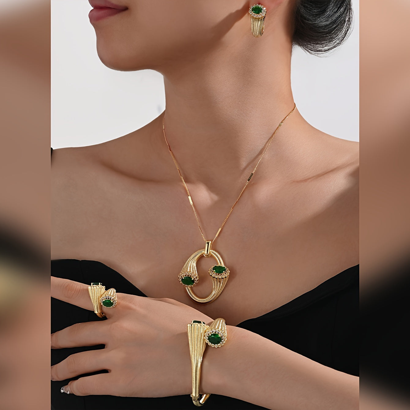 4-Piece Gold-Toned Copper Jewelry Set with zirconia Accents – Chic and stylish design perfect for any occasion. Makes the perfect Valentine's Day gift. Set includes a necklace, earrings, and two bangle-style ornamental pieces.